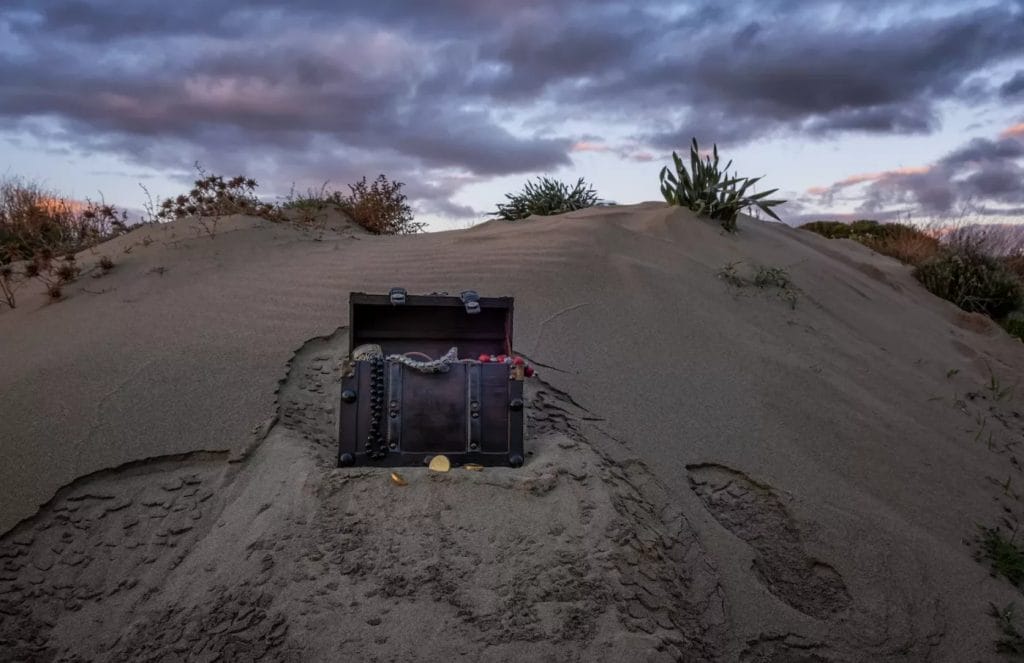 Treasure,Chest,At,The,Beach,In,A,Sunrise,,Jewels,And treasure chest at the beach in a sunrise, jewels and gold coins