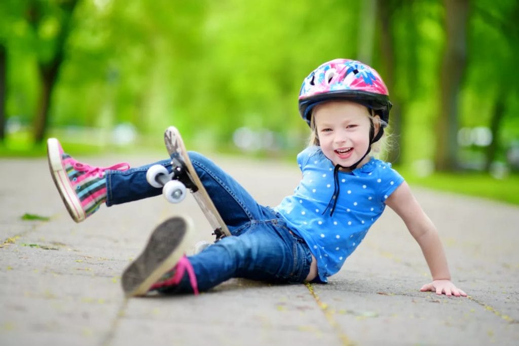 Pretty,Little,Girl,Learning,To,Skateboard,Outdoors,On,Beautiful,Summer Girl falling off a skateboard